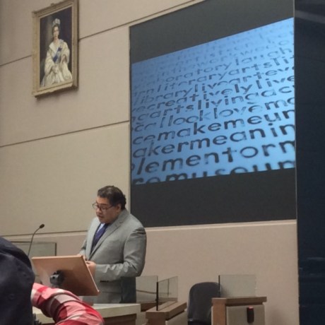 Calgary Mayor Naheed nenshi reading Richard Harrison's 'Ode to the Saddledome" under an excerpt of my visual poetry suite "Every word"